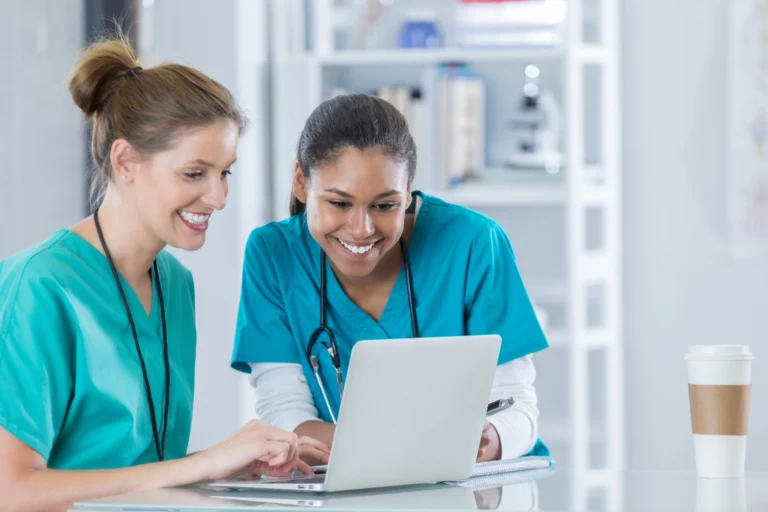 2 medical students looking at laptop